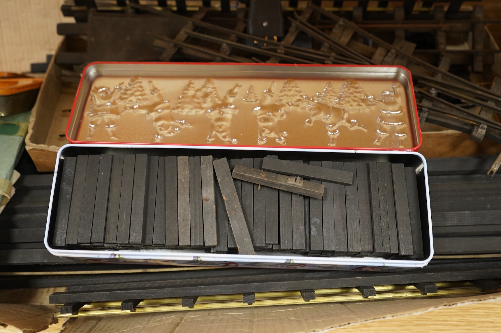 A quantity of 1930s-50s Bassett Lowke 0 gauge railway related track parts and accessories, including track sections on wooden sleepers, a Bassett-Lowke set of points, plus two handmade sets of points, track gauges, chair